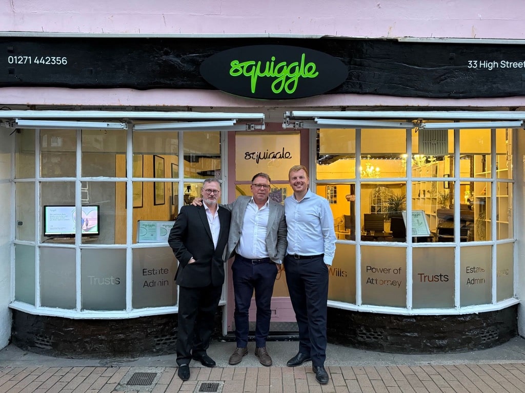 Squiggle team in front of new shop signage